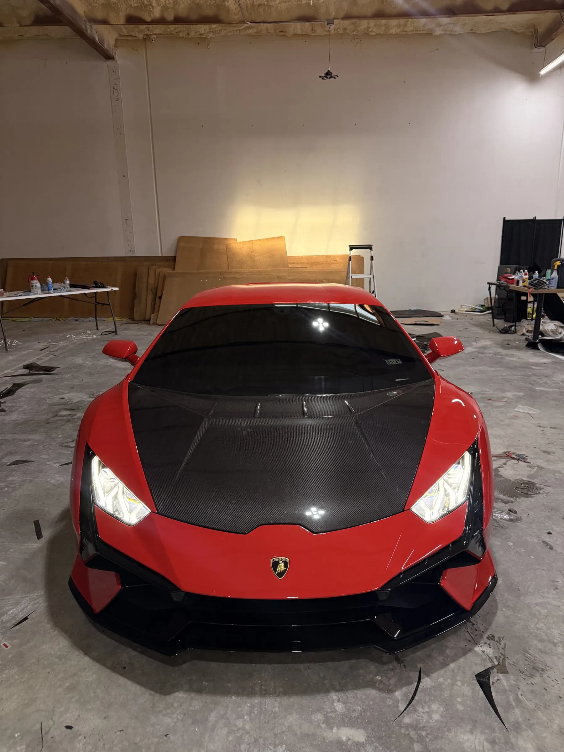 Lamborghini Huracán in red with a carbon fibre hood, in the shop
