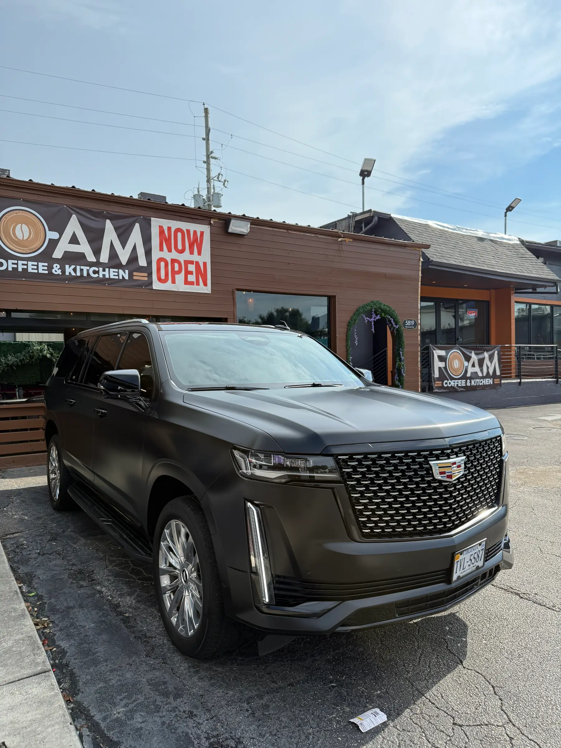 Cadillac Escalade: Matte Black wrap, front three-quarter